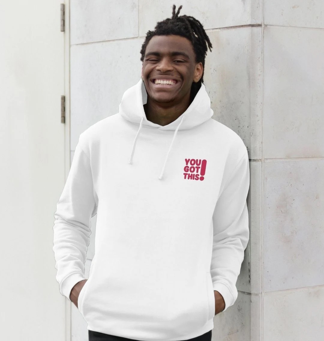 Model wearing a white hoodie with a small pink You Got This logo on the top-left chest.